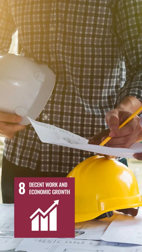 Person in plaid shirt holding a hard hat and blueprint, with a logo in the corner representing the eighth Sustainable Development Goal by the United Nations, Decent Work and Economic Growth.